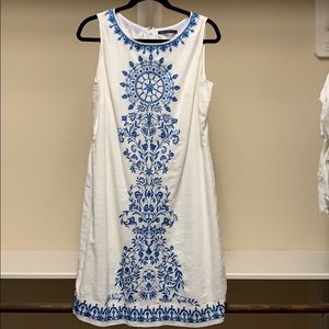 White linen dress with blue embroidery.